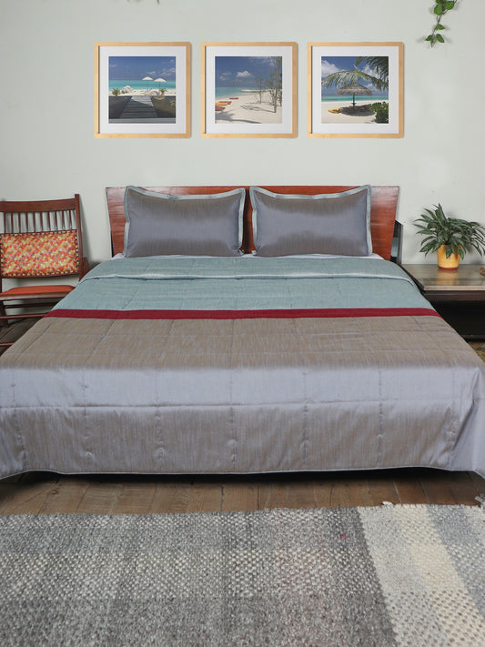 Grey colored bed quilt with 2 matching pillow covers made from polyester front and cotton backed quilt for king size double bed