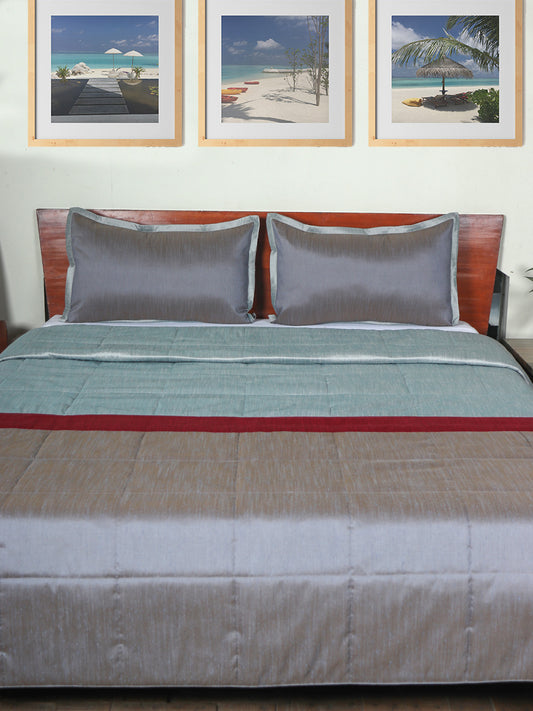 Grey colored bed quilt with 2 matching pillow covers made from polyester front and cotton backed quilt for king size double bed
