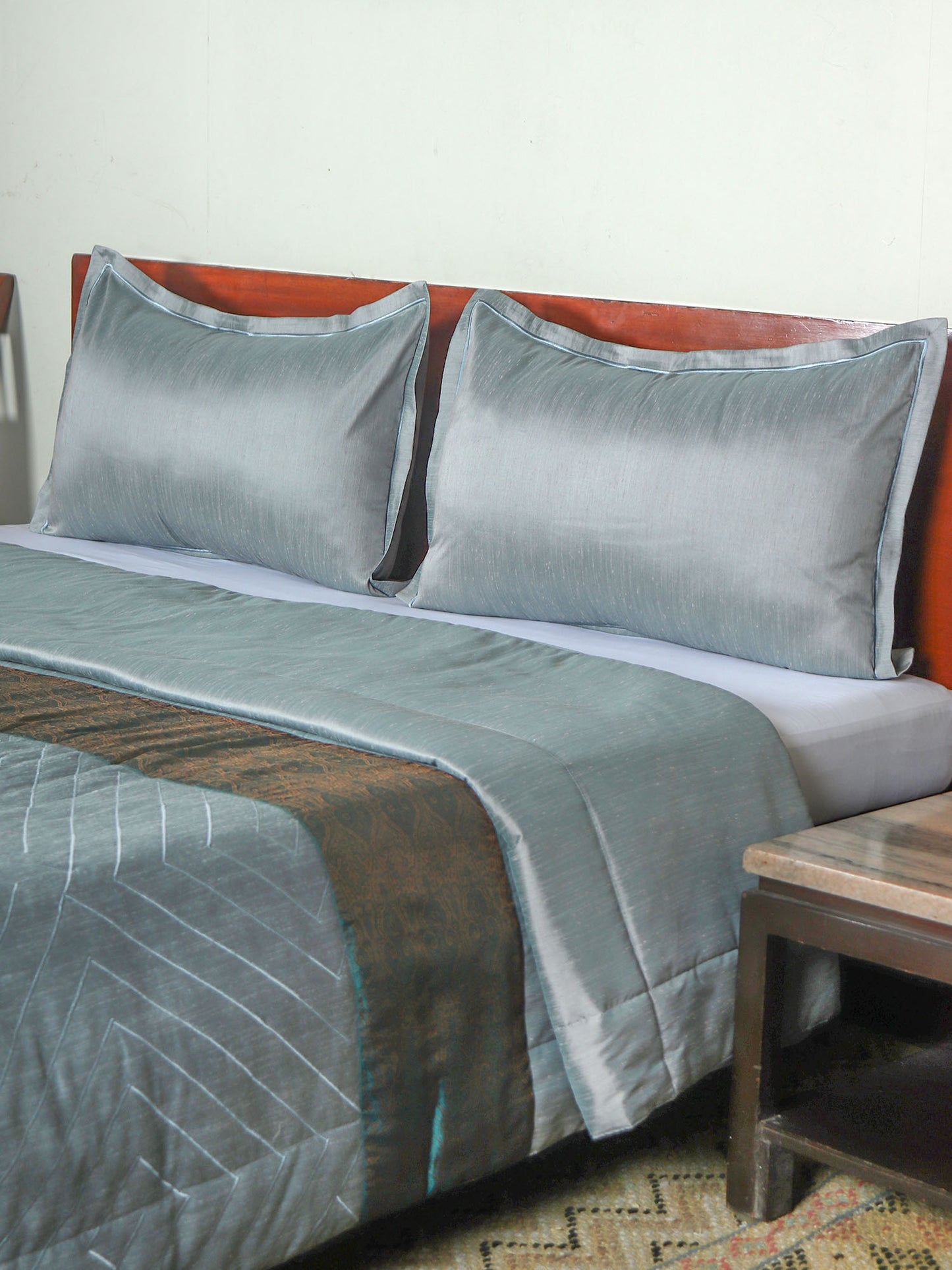 Blue colored bed quilt /comforter with patchwork and embroidery along with 2 matching pillow covers made from polyester front and cotton backed quilt for king size double bed