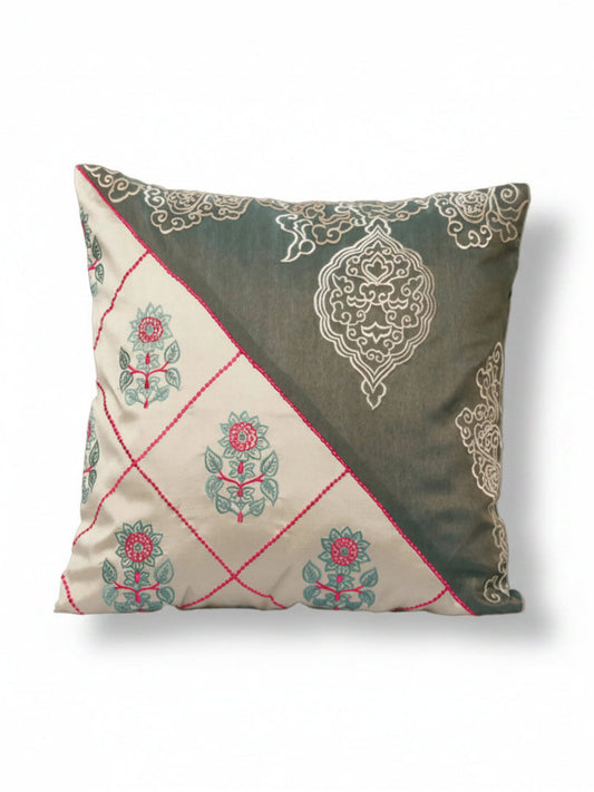 Decorative pillow with floral and paisley patterns on a beige background