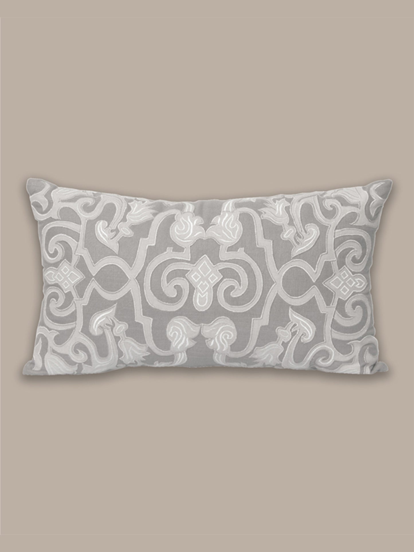 Decorative pillow with intricate pattern on a beige background
