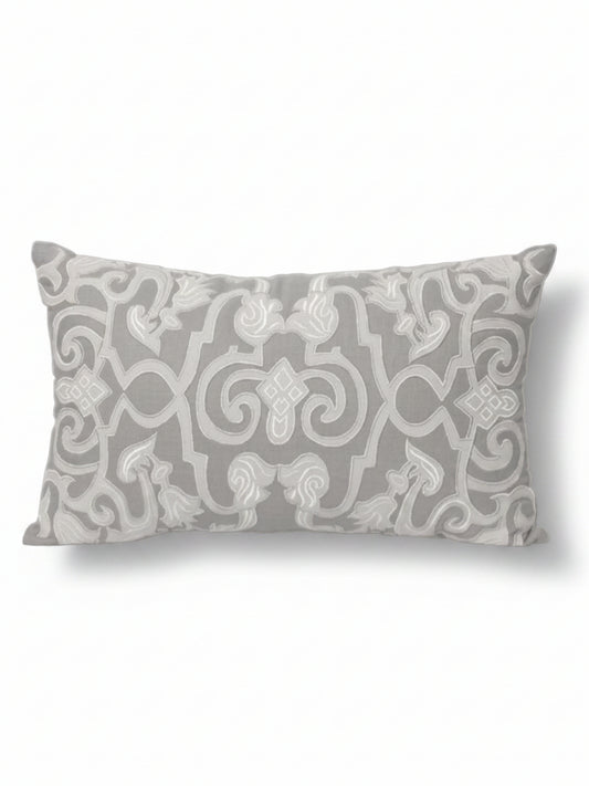 Decorative pillow with intricate pattern on a beige background