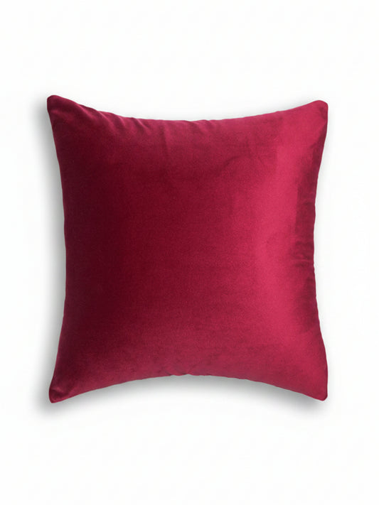 A square throw pillow in a rich magenta velvet fabric, shown against a plain white background.