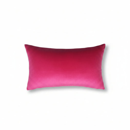 A rectangular lumbar throw pillow in a vibrant magenta pink velvet fabric, shown against a plain off-white background.