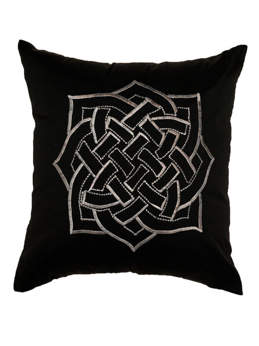 A square black throw pillow featuring a large silver Celtic knot design embroidered in the center, set against a plain white background.