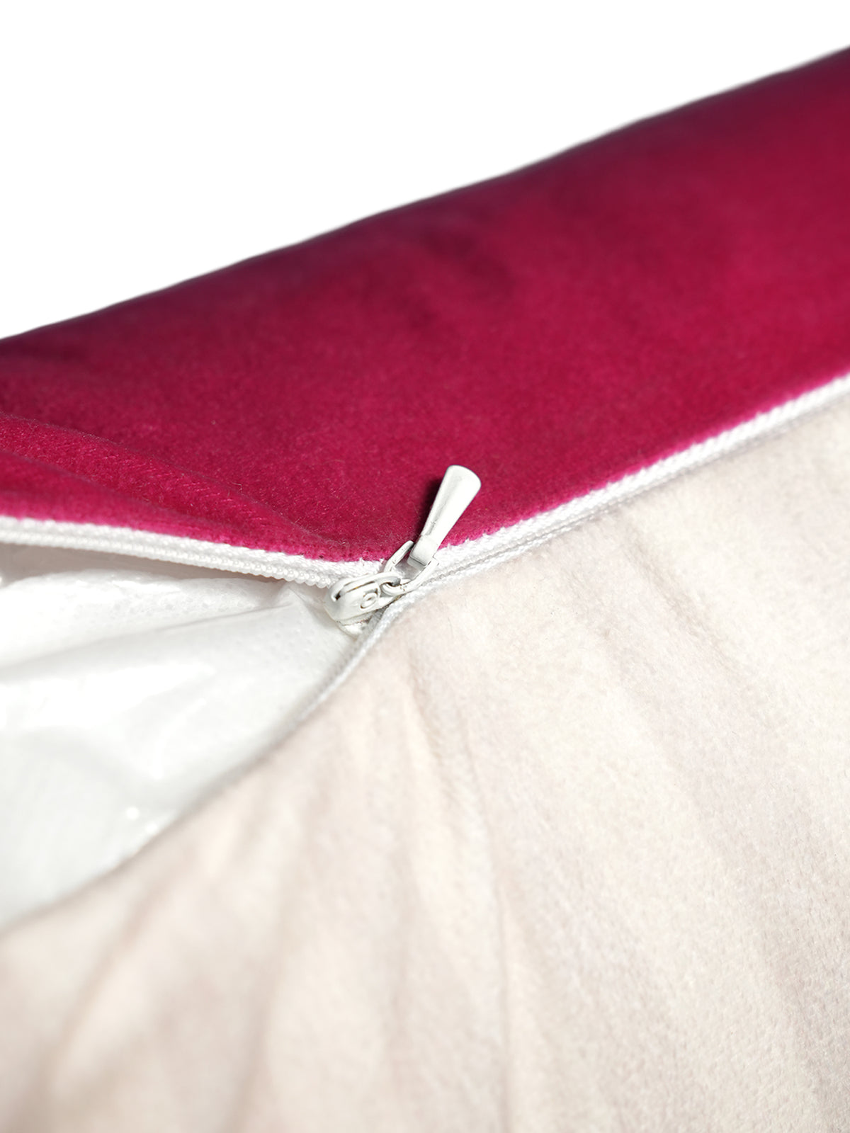 Close-up of a zipper on a red and beige fabric background