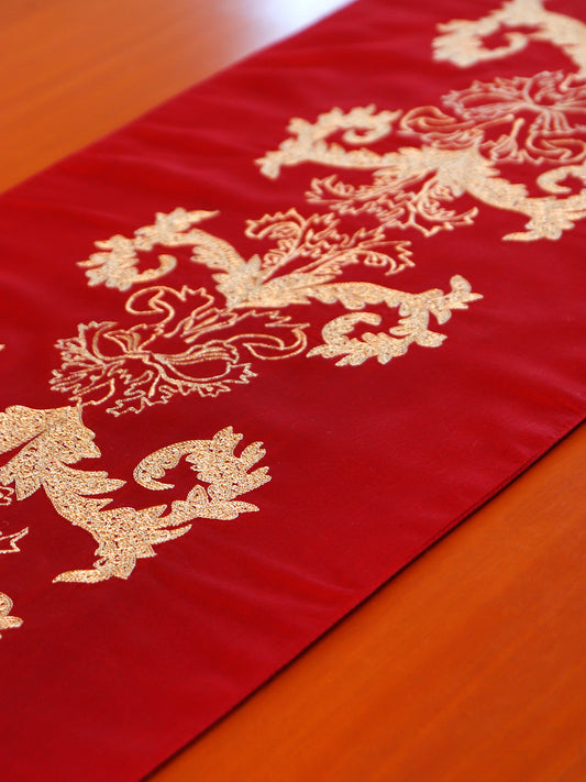 closeup of red colored embroidered table runner with tassels on corners for 6 seater table - 52x84 inches.
