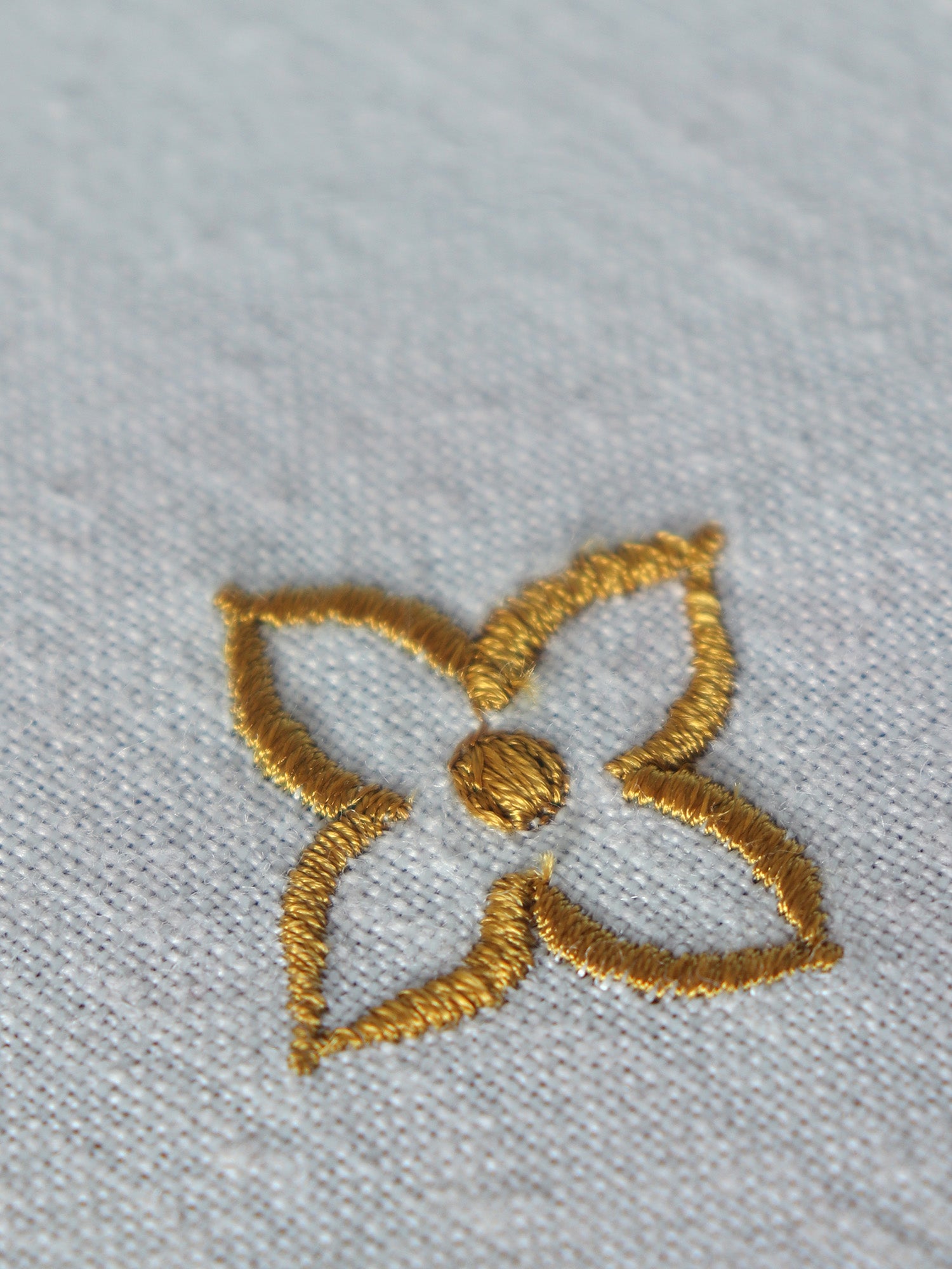 golden motif embroidery on table cover for 6 seater 