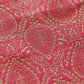 Close-up of pink fabric with gold paisley pattern