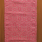 Red fabric with intricate pattern on a wooden background