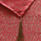 Red fabric with intricate patterns and a tassel
