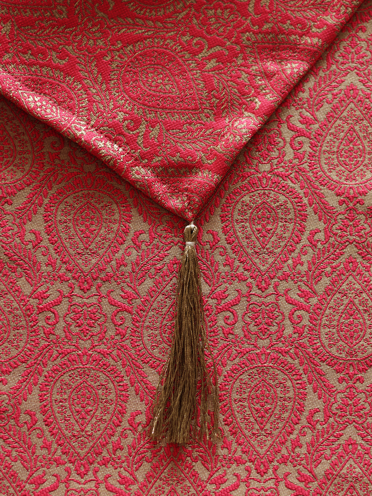 Red fabric with intricate patterns and a tassel