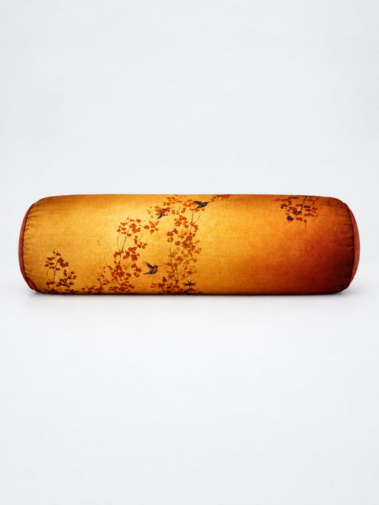 A cylindrical bolster pillow with a textured golden-yellow fabric featuring a traditional Chinese-style print of red-orange blossoms and small birds, set against a plain white background.