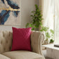 A square magenta pink throw pillow with a textured, pleated diamond pattern, shown against a plain white background.