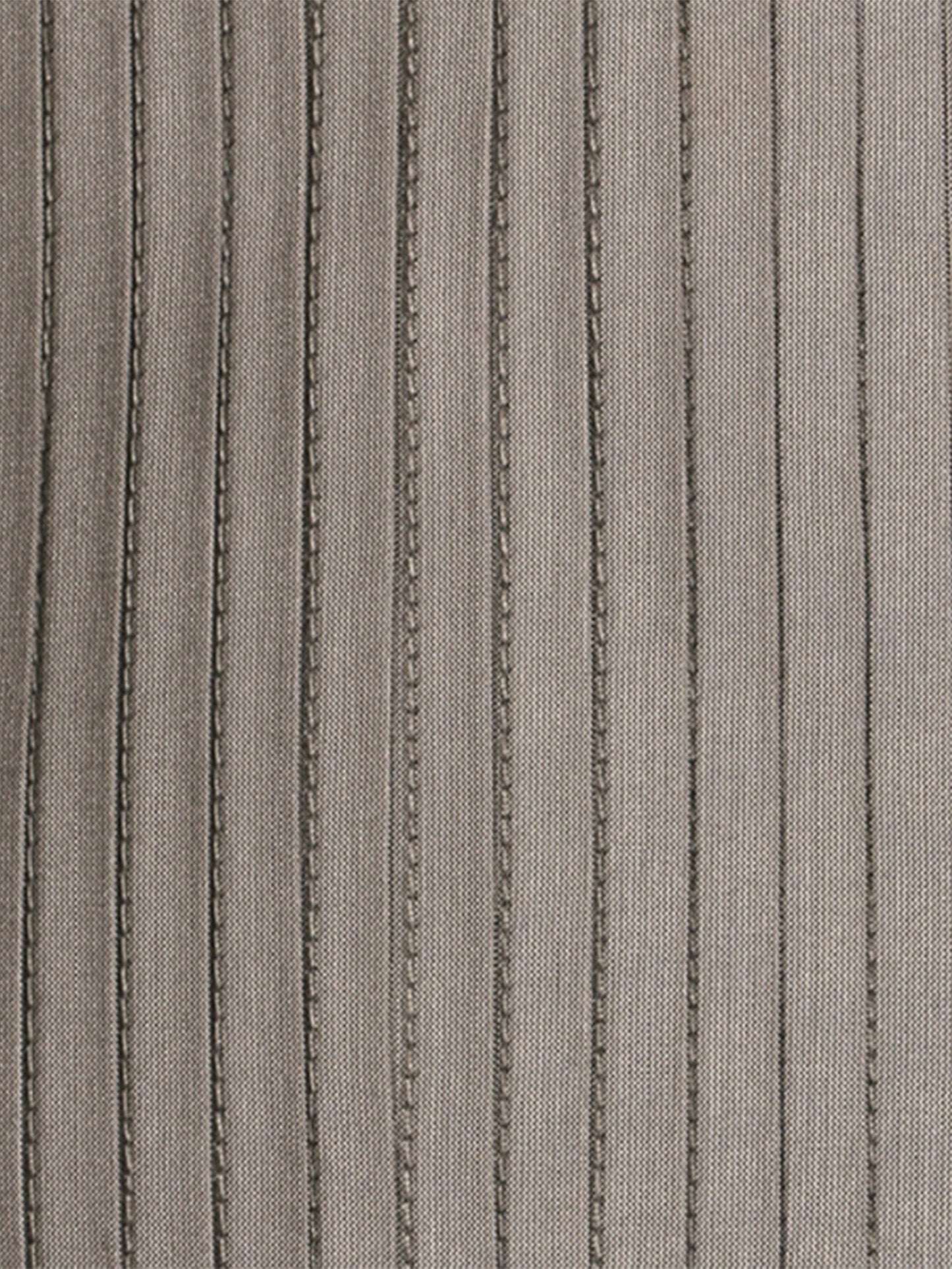 A close-up of a ribbed knit fabric in a warm taupe-gray color, featuring vertical rows of textured chain-like stitching.