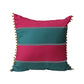 A square decorative throw pillow with horizontal stripes in vibrant pink and teal, featuring chevron stitched details and orange pom-pom trim along the edges, set against a solid gray background.