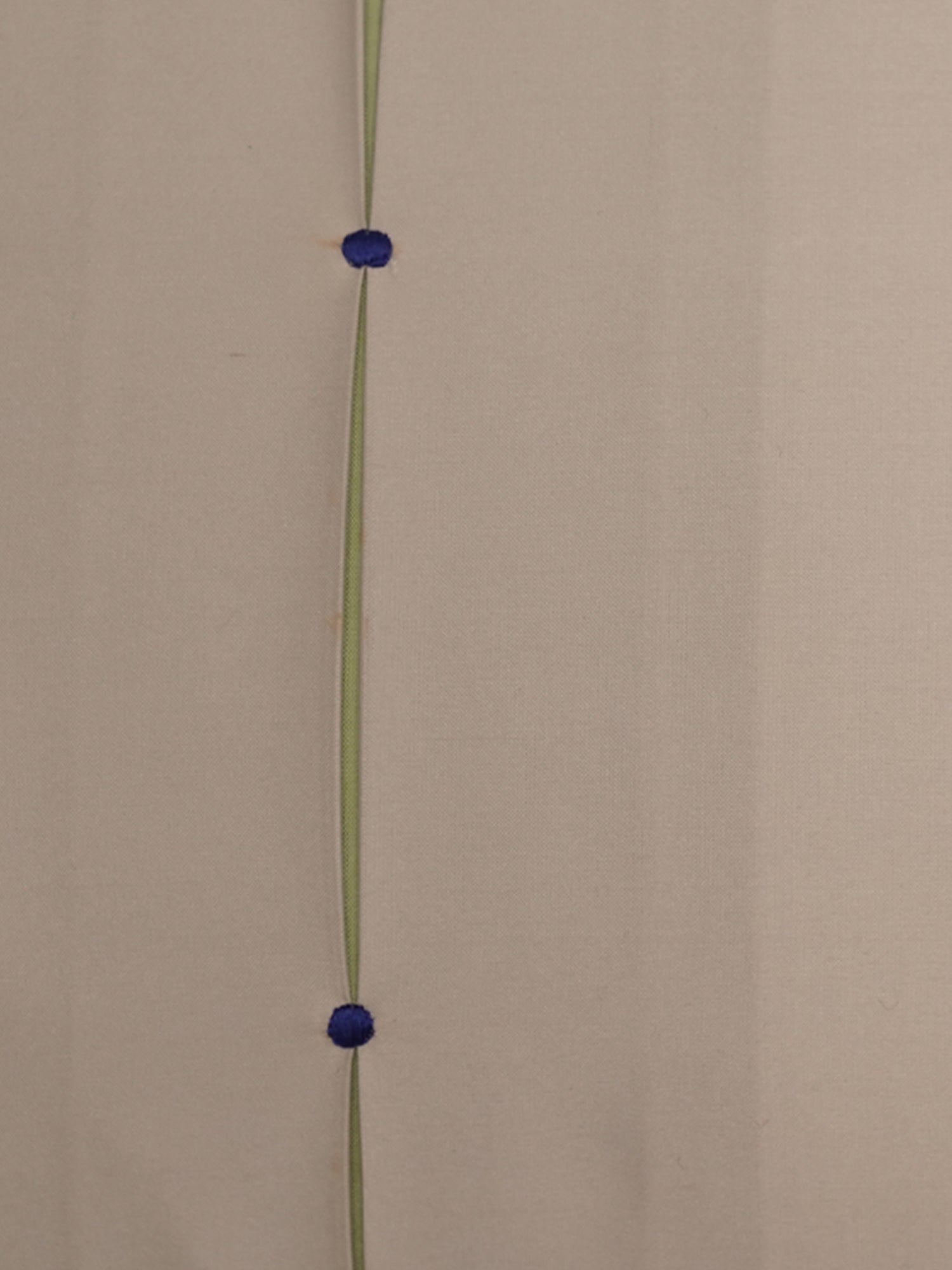 A minimalist wall art piece featuring a vertical olive green line with two small, round, dark blue metallic beads suspended at equal intervals, set against a plain beige wall.