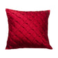 A square red decorative throw pillow with a textured diamond-quilted pattern, shown against a plain white background.
