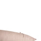A close-up of a light beige textured throw pillow against a solid white background.