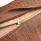Close-up of a brown and beige striped fabric zipper pouch with a silver metal zipper pull, showing the texture of the woven material.