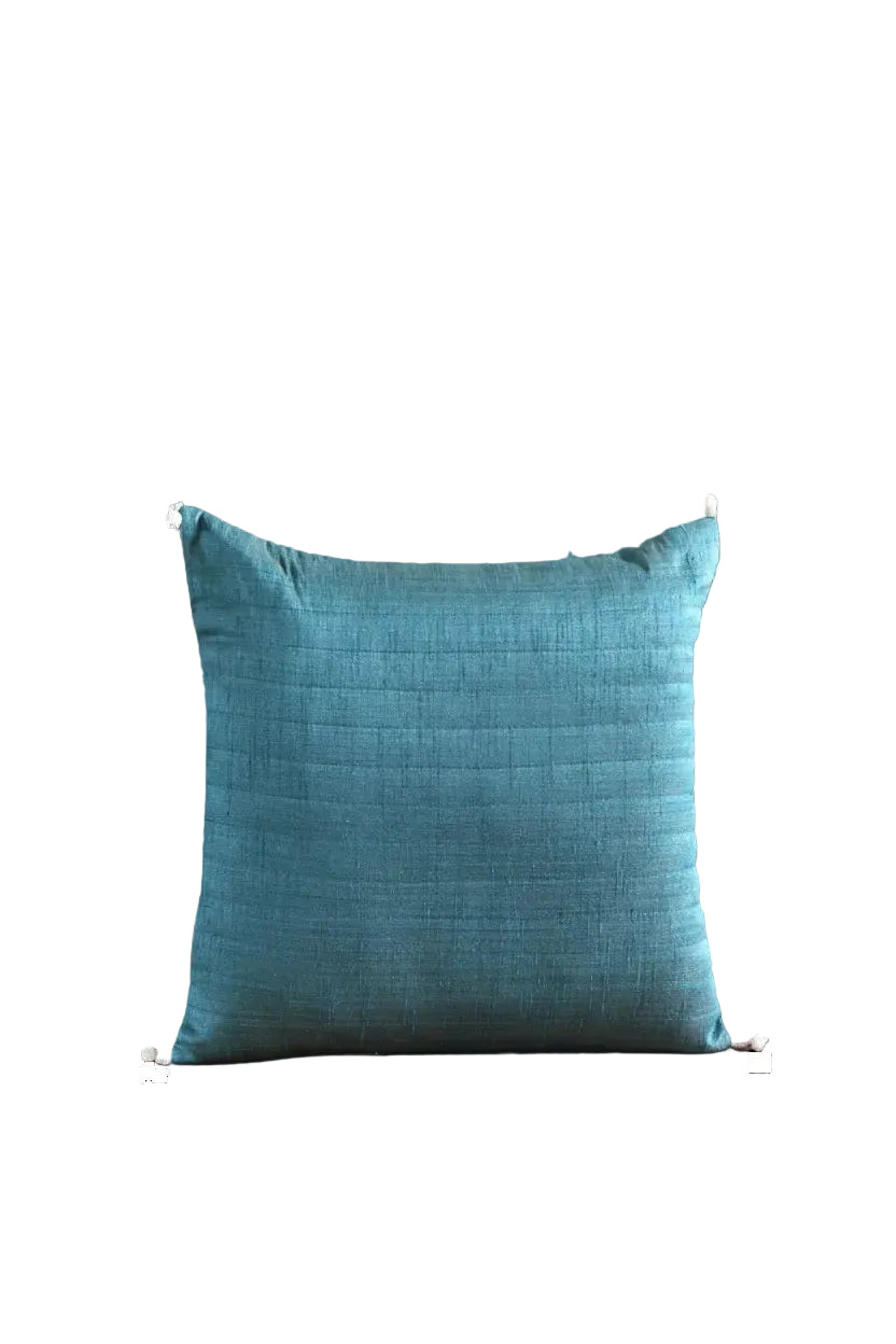 A square teal blue textured throw pillow with white corner ties, shown against a solid black background.