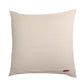 A square beige linen throw pillow with a small red fabric tag near the bottom right corner, shown against a plain white background.
