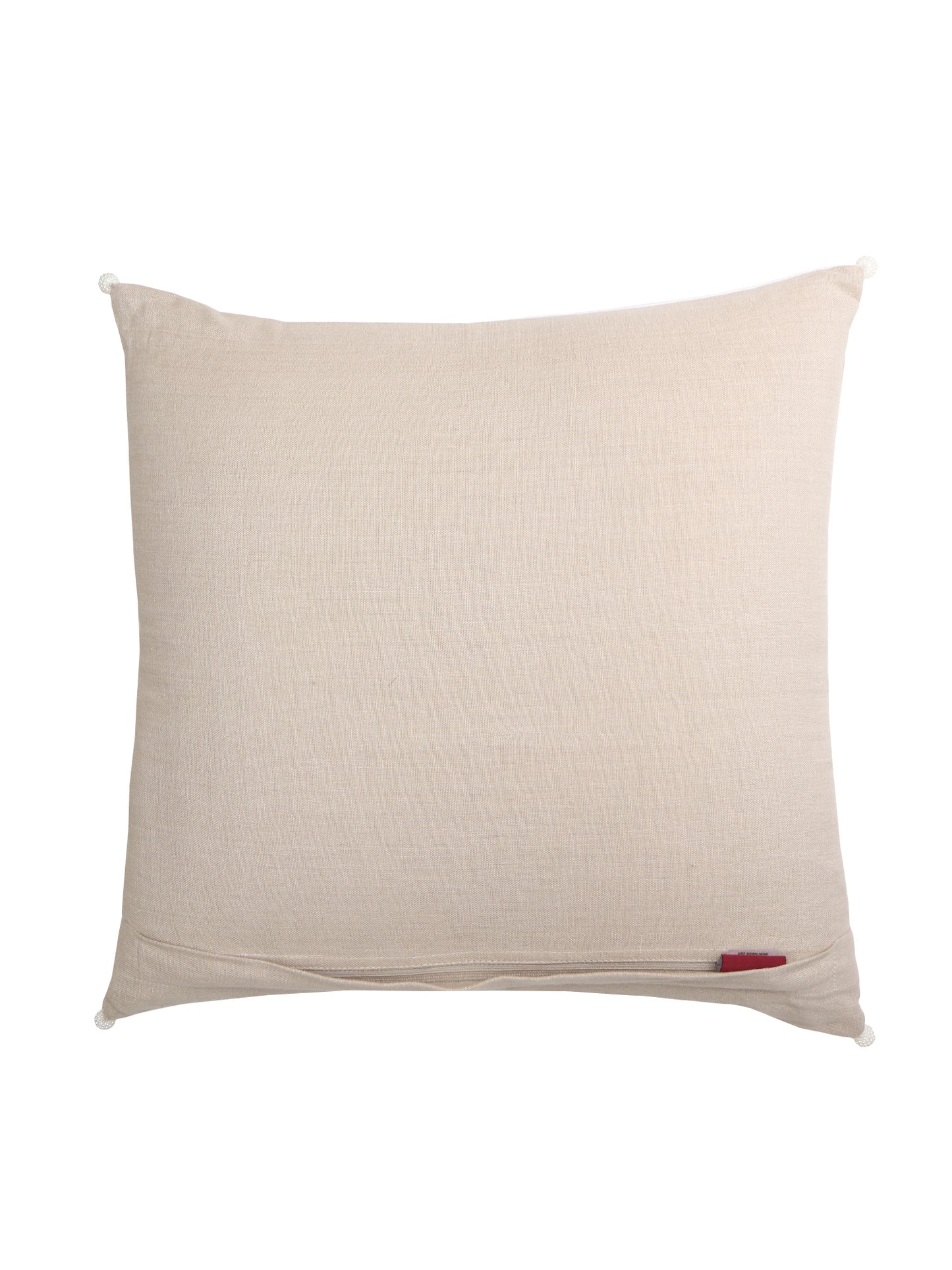A square beige linen throw pillow with a small red fabric tag near the bottom right corner, shown against a plain white background.