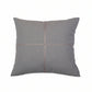 A square gray throw pillow with a textured linen-like fabric, featuring a central cross design formed by two intersecting stitched lines in a contrasting light brown color, shown against a plain white background.